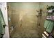 Bathroom featuring a glass-enclosed shower with tile surround and a pebble floor at 272 Orange St, Palm Harbor, FL 34683
