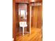 Charming bathroom with pedestal sink, wood paneling, and ample natural light at 272 Orange St, Palm Harbor, FL 34683