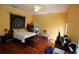 Comfortable bedroom with a ceiling fan, wood floors, and ample natural light at 272 Orange St, Palm Harbor, FL 34683