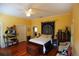 Cozy bedroom with hardwood floors, ceiling fan, and traditional furnishings at 272 Orange St, Palm Harbor, FL 34683