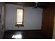 Bedroom with wooden ceiling fan, wood trim windows and dark stained hardwood floor at 272 Orange St, Palm Harbor, FL 34683