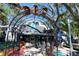 Unique entrance to Ozona Brewing Company, adorned with colorful seating and an artistic metal archway at 272 Orange St, Palm Harbor, FL 34683