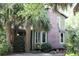 Home with brick chimney and tropical landscaping, enhancing its curb appeal at 272 Orange St, Palm Harbor, FL 34683