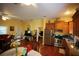 View of the kitchen area with wooden cabinets, granite countertops, and stainless-steel appliances at 272 Orange St, Palm Harbor, FL 34683