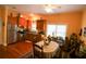 Kitchen with hardwood floors, stainless steel refrigerator, wooden cabinets, and eat-in dining table at 272 Orange St, Palm Harbor, FL 34683