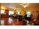 Open concept living room with hardwood floors, three windows, and three ceiling fans at 272 Orange St, Palm Harbor, FL 34683