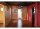 Spacious living room features hardwood floors, wood paneling, and a ceiling fan at 272 Orange St, Palm Harbor, FL 34683