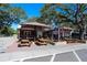 Outdoor seating area of a restaurant with picnic tables and umbrellas for shade at 272 Orange St, Palm Harbor, FL 34683
