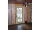 Unfinished room with hard wood floors, drop ceiling, and white trim window with door to exterior at 272 Orange St, Palm Harbor, FL 34683
