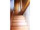 Wooden staircase with a railing leading to the upper level of the home at 272 Orange St, Palm Harbor, FL 34683