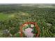Aerial shot showcases expansive property surrounded by lush greenery with a large private lot at 27511 Hialeah Way, Wesley Chapel, FL 33544
