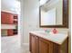 Stylish vanity features framed mirror and doorway view into an adjoining office space at 27511 Hialeah Way, Wesley Chapel, FL 33544