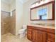 Bathroom with tiled shower and vanity with granite countertop at 27511 Hialeah Way, Wesley Chapel, FL 33544