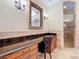 Elegant bathroom featuring a vanity with granite countertop, makeup area, and glass-enclosed shower at 27511 Hialeah Way, Wesley Chapel, FL 33544