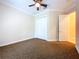 Clean bedroom includes carpeted floors, ceiling fan, and convenient access to the closet and hallway at 27511 Hialeah Way, Wesley Chapel, FL 33544