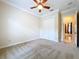 Neutral bedroom with ceiling fan, closet, and adjacent doorway at 27511 Hialeah Way, Wesley Chapel, FL 33544