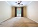 Spacious bedroom with a ceiling fan and French doors at 27511 Hialeah Way, Wesley Chapel, FL 33544