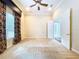 Large bedroom with a ceiling fan, a window, and an open doorway leading to another room at 27511 Hialeah Way, Wesley Chapel, FL 33544