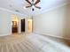 Large bedroom with ceiling fan and views to other rooms at 27511 Hialeah Way, Wesley Chapel, FL 33544