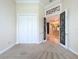 The bedroom features neutral carpeting, a double closet, and a decorative doorway leading to the rest of the house at 27511 Hialeah Way, Wesley Chapel, FL 33544
