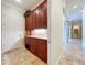 Traditional butlery featuring ample cherry wood cabinetry, granite counters and easy access to entry at 27511 Hialeah Way, Wesley Chapel, FL 33544