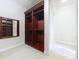 Walk-in closet with custom shelving and mirrored storage for optimal organization in bedroom suite at 27511 Hialeah Way, Wesley Chapel, FL 33544