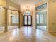 Spacious foyer features marble floors, elegant lighting, and stately columns creating an inviting atmosphere at 27511 Hialeah Way, Wesley Chapel, FL 33544