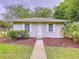Cozy one-story home with white trim, well-maintained lawn, and a welcoming walkway at 27511 Hialeah Way, Wesley Chapel, FL 33544