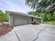 Attached garage with long driveway, featuring a secure entrance to the property at 27511 Hialeah Way, Wesley Chapel, FL 33544