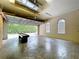 Expansive garage with open door, with space for vehicles, projects, with good lighting and air flow at 27511 Hialeah Way, Wesley Chapel, FL 33544