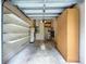 The garage has built-in shelving and storage space for organizing tools and household items at 27511 Hialeah Way, Wesley Chapel, FL 33544