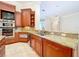 Gourmet kitchen featuring custom cabinets, granite counters, and a central island at 27511 Hialeah Way, Wesley Chapel, FL 33544