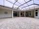 Large screened lanai with brick flooring, multiple seating areas, and seamless indoor-outdoor living at 27511 Hialeah Way, Wesley Chapel, FL 33544