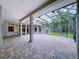 Expansive screened lanai features a brick floor and unobstructed views of the backyard at 27511 Hialeah Way, Wesley Chapel, FL 33544