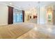 Open concept living area with sliding glass doors and elegant draperies at 27511 Hialeah Way, Wesley Chapel, FL 33544