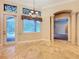 Bright living area with Travertine floors, decorative windows, and easy access to a screened patio at 27511 Hialeah Way, Wesley Chapel, FL 33544
