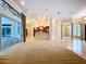 Expansive living area featuring sliding glass doors and access to the kitchen at 27511 Hialeah Way, Wesley Chapel, FL 33544