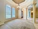 Bright living room featuring arched windows, chandelier, and decorative columns at 27511 Hialeah Way, Wesley Chapel, FL 33544