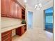 Dedicated home office space with built-in desk, cabinets, and open shelving for organization at 27511 Hialeah Way, Wesley Chapel, FL 33544