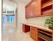 Spacious office area with custom wood cabinets, granite countertop, and ample storage space at 27511 Hialeah Way, Wesley Chapel, FL 33544
