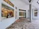 Covered patio showcases brick flooring, decorative ironwork and views into the interior at 27511 Hialeah Way, Wesley Chapel, FL 33544