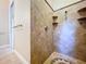 Beautiful tile shower featuring built-in shelves, mosaic tile flooring and classic trim at 27511 Hialeah Way, Wesley Chapel, FL 33544