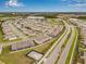 Aerial view of home's location in a neighborhood near community park and commercial buildings at 2771 Suncoast Blend Dr, Odessa, FL 33556