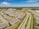 Aerial view of home's location in a neighborhood with other homes and commercial buildings nearby at 2771 Suncoast Blend Dr, Odessa, FL 33556