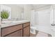 Well-lit bathroom featuring a vanity with wood cabinets and a shower-tub combination at 2771 Suncoast Blend Dr, Odessa, FL 33556