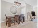 Inviting dining room with wood table, decorative clock, and a modern rustic light fixture at 2771 Suncoast Blend Dr, Odessa, FL 33556