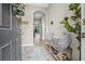 View of entryway with ceramic tile flooring, coat rack with bench, gray pillows and decorative touches at 2771 Suncoast Blend Dr, Odessa, FL 33556