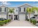 Charming townhome with a well-maintained front yard, lovely palm trees, and a one car garage at 2771 Suncoast Blend Dr, Odessa, FL 33556