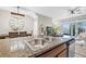 Well-equipped kitchen featuring granite countertops, wooden cabinets, island seating and stainless steel appliances at 2771 Suncoast Blend Dr, Odessa, FL 33556