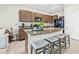 Well-equipped kitchen featuring granite countertops, wooden cabinets, island seating and stainless steel appliances at 2771 Suncoast Blend Dr, Odessa, FL 33556